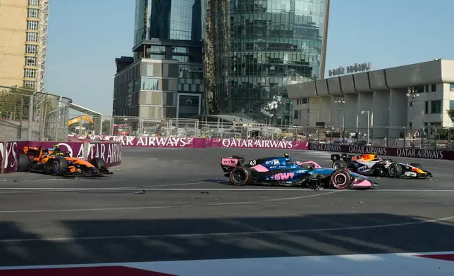 Alpine driver Franco Colapinto of Argentina, center, crashes with McLaren driver Lando Norris of Britain, left, and Racing Bulls driver Liam Lawson of New Zealand during the Azerbaijan F1 Grand Prix auto race, in Baku, Azerbaijan, Saturday, Sept. 26, 2026. (AP Photo/Darko Bandic)