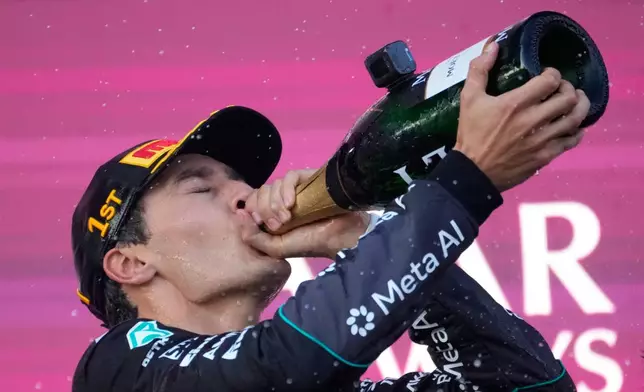 Mercedes driver George Russell of Britain celebrates after winning the Azerbaijan F1 Grand Prix auto race, in Baku, Azerbaijan, Saturday, Sept. 26, 2026. (AP Photo/Pavel Bednyakov)