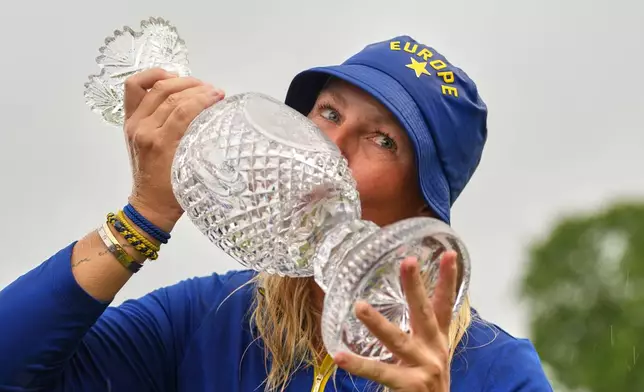 Anna Nordqvist, Europe team captain, kisses the trophy after her team won the Solheim Cup in Den Bosch, Netherlands, Sunday, Sept. 13, 2026. (AP Photo/Alastair Grant)