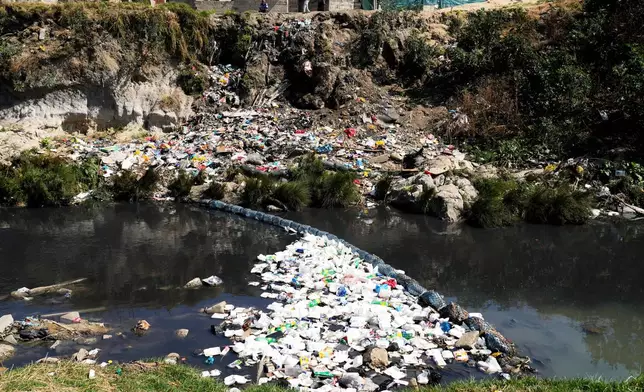 Piles of plastic waste and debris float along the Jukskei River in Alexandra township, Johannesburg, South Africa, Friday, Sept. 11, 2026. (AP Photo/Themba Hadebe)