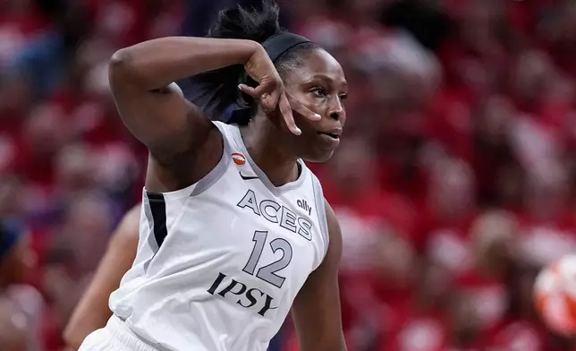Las Vegas Aces guard Chelsea Gray (12) celebrates a three-point basket against the Indiana Fever during the first half in Game 2 of a WNBA basketball first-round playoff series in Indianapolis, Tuesday, Sept. 29, 2026. (AP Photo/Michael Conroy)