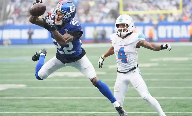 New York Giants cornerback Dru Phillips (22) breaks up a pass intended for Tennessee Titans wide receiver Wan'Dale Robinson (4) during the second half of an NFL football game in East Rutherford, N.J., Sunday, Sept. 27, 2026. (AP Photo/Frank Franklin II)