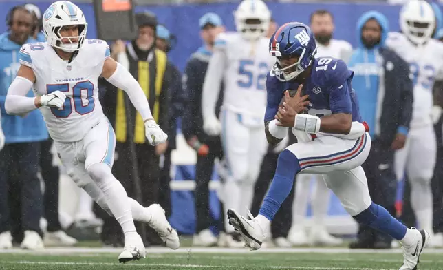 New York Giants quarterback Jameis Winston (19) runs for a first down past Tennessee Titans linebacker Cody Barton (50) during the second half of an NFL football game in East Rutherford, N.J., Sunday, Sept. 27, 2026. (AP Photo/Adam Hunger)