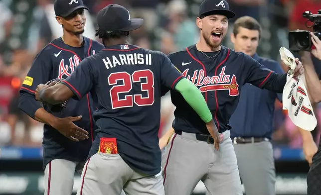 Atlanta Braves' Michael Harris II (23) and DaShawn Keirsey Jr., front right, celebrate on the field after a baseball game against the Houston Astros as they clinched the NL East title, Sunday, Sept. 20, 2026, in Houston. (AP Photo/Karen Warren)