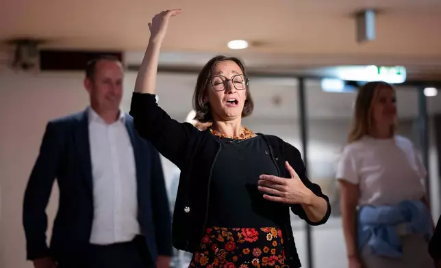 A woman yodels during a public event in an underground garage in Graz, Austria, on Wednesday, Sept. 23, 2026. (AP Photo/Denes Erdos)