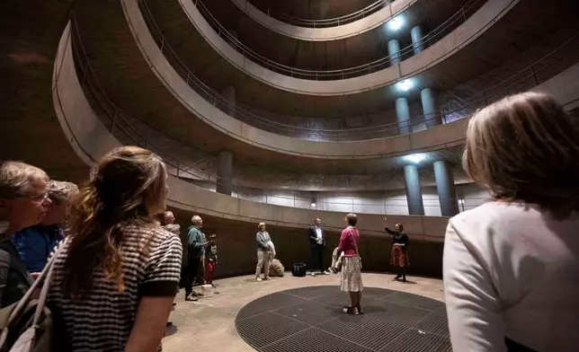 People yodel during a public event in an underground garage in Graz, Austria, on Wednesday, Sept. 23, 2026. (AP Photo/Denes Erdos)
