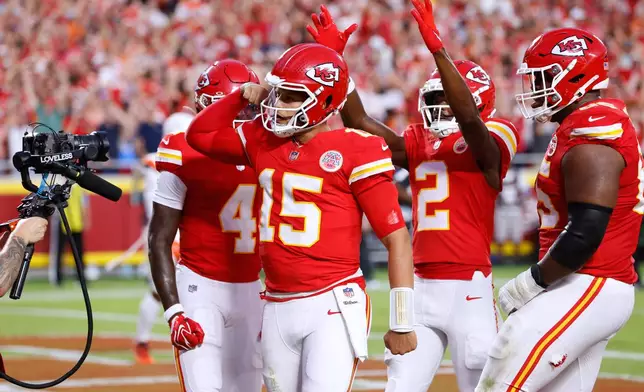 Kansas City Chiefs quarterback Patrick Mahomes (15) celebrates his touchdown run with teammates wide receiver Rashee Rice (4), wide receiver Tyquan Thornton (2) and guard Trey Smith (65) during the first half of an NFL football game against the Denver Broncos, Monday, Sept. 14, 2026, in Kansas City, Mo. (AP Photo/Colin E. Braley)