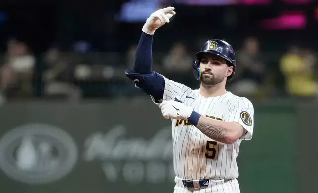 Milwaukee Brewers' Garrett Mitchell gestures after hitting a two-run double during the fifth inning of a baseball game against the Cincinnati Reds, Saturday, Sept. 12, 2026, in Milwaukee. (AP Photo/Aaron Gash)