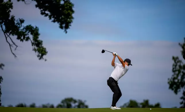 International teams' Min Woo Lee, of Australia, hits from the sixth fairway against the USA team during the first round four-ball match at the Presidents Cup golf tournament at Medinah Country Club, Thursday, Sept. 24, 2026, in Medinah, Ill. (AP Photo/Matt Slocum)