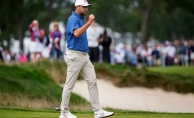 USA teams' Scottie Scheffler reacts to making his birdie putt on the first hole against the International teams during the first round four-ball match at the Presidents Cup golf tournament at Medinah Country Club, Thursday, Sept. 24, 2026, in Medinah, Ill. (AP Photo/Matt Slocum)