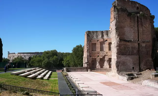 The southwestern exedra of the Baths of Trajan, backdropped by the Colosseum, sits above the underground foundations where the restored "Painted City" fresco and Great Mosaic were discovered in the 1990s, in Rome, Sept. 8, 2026. (AP Photo/Andrew Medichini)