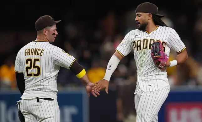 San Diego Padres right fielder Fernando Tatis Jr., right, celebrates with first baseman Ty France after the Padres defeated the Washington Nationals 5-4 in a baseball game Tuesday, Sept. 8, 2026, in San Diego. (AP Photo/Gregory Bull)