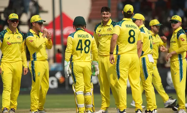 Australia's bowler Matt Renshaw, center, celebrates a wicket with teammates during a second one day international cricket match between Zimbabwe and Australia in Harare, Zimbabwe, Friday, Sept.18, 2026. (AP Photo/Wonder Mashura)
