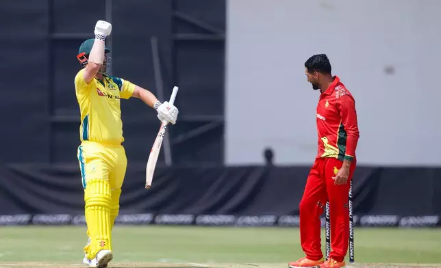 Australia's batsman Travis Head, left, celebrates his half century next to Zimbabwe's captain Sikandar Butt during the second-one day international cricket match between Zimbabwe and Australia in Harare, Zimbabwe, Friday, Sept.18, 2026. (AP Photo/Wonder Mashura)