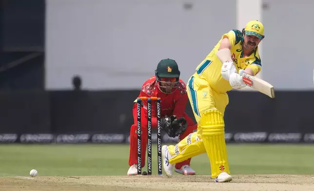 Australia's Travis Head, right, plays a shot as Zimbabwe wicketkeeper Brendan Taylor watches during the second one-day international cricket match between Zimbabwe and Australia in Harare, Zimbabwe, Friday, Sept. 18, 2026. (AP Photo/Wonder Mashura)