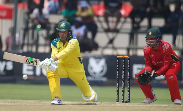 Australia's batsman Alex Carey, left, plays a shot whilst Zimbabwe's wicketkeeper Brendan Taylor watches on during the second one-day international cricket match between Zimbabwe and Australia in Harare, Zimbabwe, Friday, Sept.18, 2026. (AP Photo/Wonder Mashura)