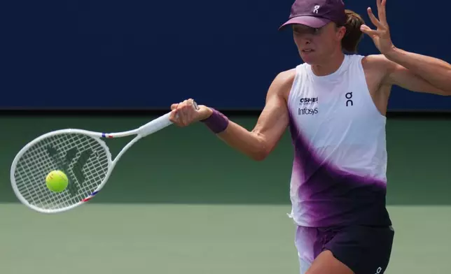 Iga Swiatek, of Poland, returns the ball to Nadia Podoroska, of Argentina, during the second round of the U.S. Open tennis championships Thursday, Sept. 3, 2026, in New York. (AP Photo/Kirsty Wigglesworth)