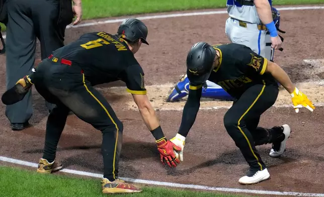 Pittsburgh Pirates' Brandon Lowe, right, celebrates with Konnor Griffin (6) after hitting a two-run home run off Kansas City Royals pitcher Randy Dobnak during the third inning of a baseball game in Pittsburgh, Friday, Sept. 18, 2026. (AP Photo/Gene J. Puskar)