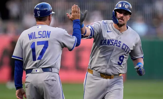 Kansas City Royals' Vinnie Pasquantino (9) rounds third to greetings from third base coach Vance Wilson (17) after hitting a solo home run off Pittsburgh Pirates pitcher Paul Skenes during the first inning of a baseball game in Pittsburgh, Friday, Sept. 18, 2026. (AP Photo/Gene J. Puskar)