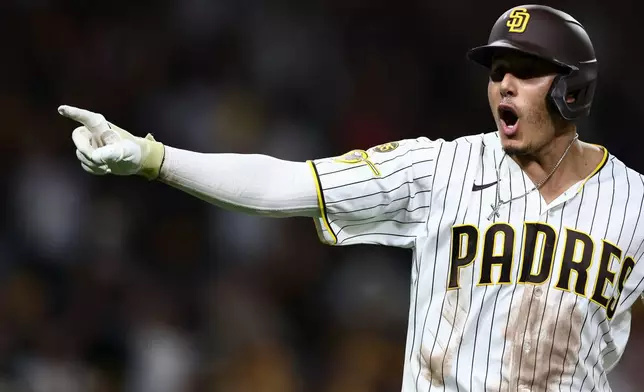 San Diego Padres' Manny Machado celebrates after his three-run home run in the fourth inning of a baseball game against the Arizona Diamondbacks, Saturday, Sept. 26, 2026, in San Diego. (AP Photo/Karl Anderson)