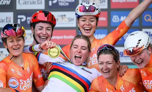 Demi Vollering, center, of the Netherlands, celebrates with teammates after winning women's elite road race at the UCI Road World Championships cycling event in Montreal, Saturday, Sept. 26, 2026. (Graham Hughes/The Canadian Press via AP)