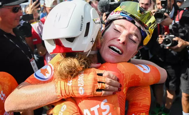 Demi Vollering, right, of the Netherlands, is congratulated by teammate Puck Pieterse after winning the women's elite road race at the UCI Road World Championships cycling event in Montreal, Saturday, Sept. 26, 2026. (Graham Hughes/The Canadian Press via AP)