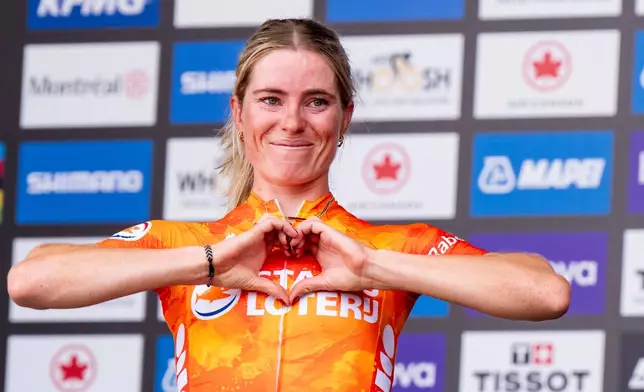 Demi Vollering, of the Netherlands, celebrates her win following women's elite road race at the UCI Road World Championships cycling event in Montreal, Saturday, Sept. 26, 2026. (Christopher Katsarov/The Canadian Press via AP)