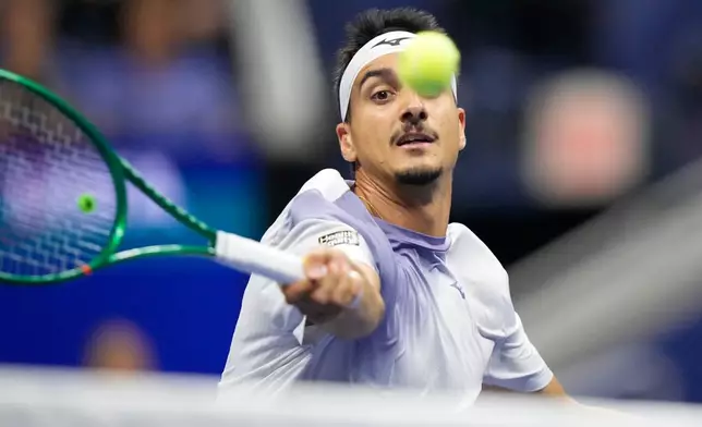 Lorenzo Sonego, of Italy, hits a return to Alexander Zverev, of Germany, in the fourth set during the first round of the U.S. Open tennis championships early Wednesday, Sept. 2, 2026, in New York. (AP Photo/Frank Franklin II)