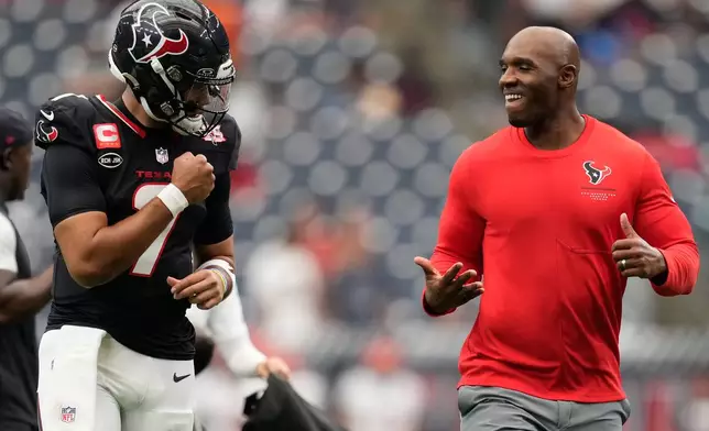 Houston Texans quarterback C.J. Stroud, left, and Houston Texans head coach DeMeco Ryans, right, looks to each other before an NFL football game against the Cincinnati Bengals in Houston, Sunday, Sept. 20, 2026. (AP Photo/Ashley Landis)