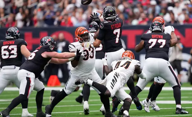 Houston Texans quarterback C.J. Stroud (7) throws under pressure from Cincinnati Bengals defensive tackle Jonathan Allen (93) and linebacker Demetrius Knight Jr. (44) during the first half of an NFL football game in Houston, Sunday, Sept. 20, 2026. (AP Photo/David J. Phillip)