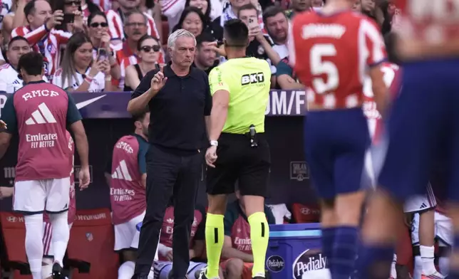 Real Madrid's head coach Jose Mourinho speaks to Referee Miguel Angel Ortiz Arias during a Spanish La Liga soccer match between Atletico Madrid and Real Madrid in Madrid, Sunday, Sept. 20, 2026. (AP Photo/Bernat Armangue)