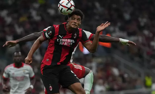 AC Milan's Koni De Winter goes for the header with Benfica's Jhon Duran during the Europa League opening phase soccer match between AC Milan and Benfica in Milan, Italy, Wednesday, Sept. 16, 2026. (AP Photo/Antonio Calanni)