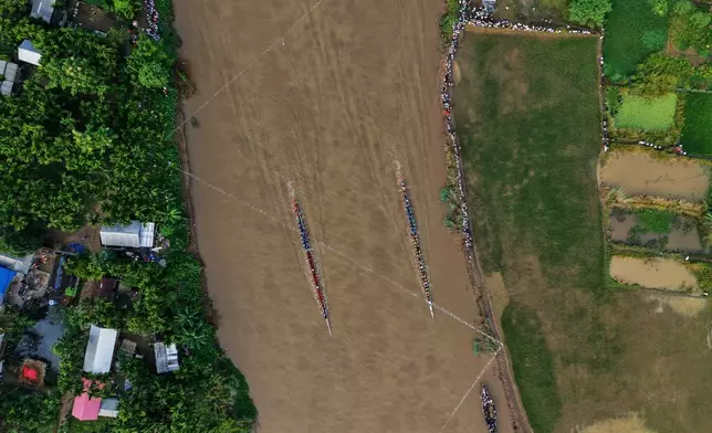 Participants take part in the traditional boat race on the Kulsi river in Champupara village, west of Guwahati, India, Thursday, Sept. 17, 2026. (AP Photo/Anupam Nath)