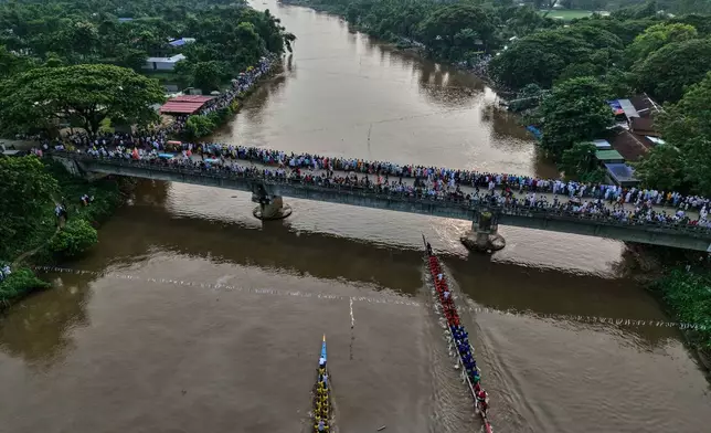 Participants take part in the traditional boat race on the Kulsi river in Champupara village, west of Guwahati, India, Thursday, Sept. 17, 2026. (AP Photo/Anupam Nath)