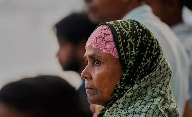 Villagers watch as participants take part in the traditional boat race on the Kulsi river in Champupara village, west of Guwahati, India, Thursday, Sept. 17, 2026. (AP Photo/Anupam Nath)