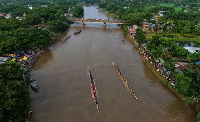 Participants take part in the traditional boat race on the Kulsi river in Champupara village, west of Guwahati, India, Thursday, Sept. 17, 2026. (AP Photo/Anupam Nath)