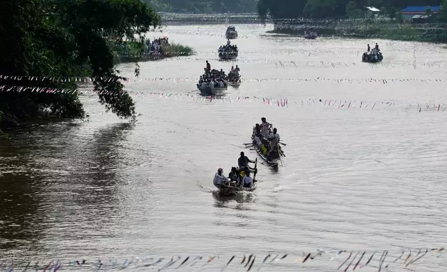 Participants take part in the traditional boat race on the Kulsi river in Champupara village, west of Guwahati, India, Thursday, Sept. 17, 2026. (AP Photo/Anupam Nath)