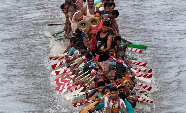 Participants take part in the traditional boat race on the Kulsi river in Champupara village, west of Guwahati, India, Thursday, Sept. 17, 2026. (AP Photo/Anupam Nath)
