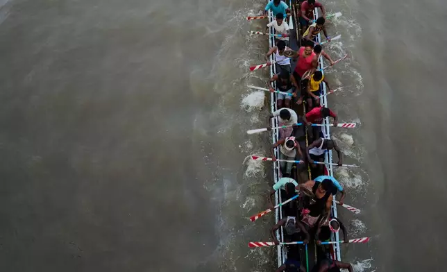 Participants take part in the traditional boat race on the Kulsi river in Champupara village, west of Guwahati, India, Thursday, Sept. 17, 2026. (AP Photo/Anupam Nath)