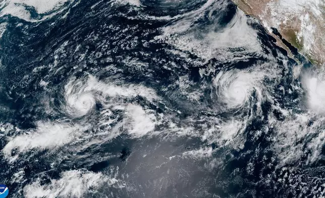 This satellite image provided by NOAA shows Tropical Storm Nolo, left, south of Hawaii; Hurricane Odalys, middle, and Hurricane Polo, right, off the coast of Mexico, in the Pacific Ocean on Thursday, Sept. 24, 2026. (NOAA via AP)