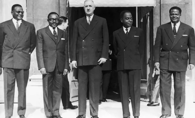FILE - From left, Nigerian President Hamani Diori, Burkina Faso President Maurice Yameogo, French President Charles de Gaulle, Ivory Coast President Felix Houphouet-Boigny and Benin President Hubert Maga pose for a photo after a summit in Paris on March 7, 1961. (AP Photo/Levy, File)