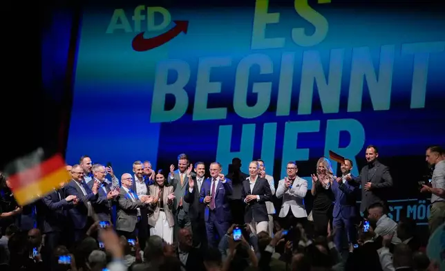 Top candidate Ulrich Siegmund and party leaders Tino Chrupalla and Alice Weidel, speak to party members in front of a reading "it starts here" at an election party of the "Alternative for Germany" (AfD) after the Saxony-Anhalt state elections in Magdeburg, eastern Germany, Sunday, Sept. 6, 2026. (AP Photo/Matthias Schrader)