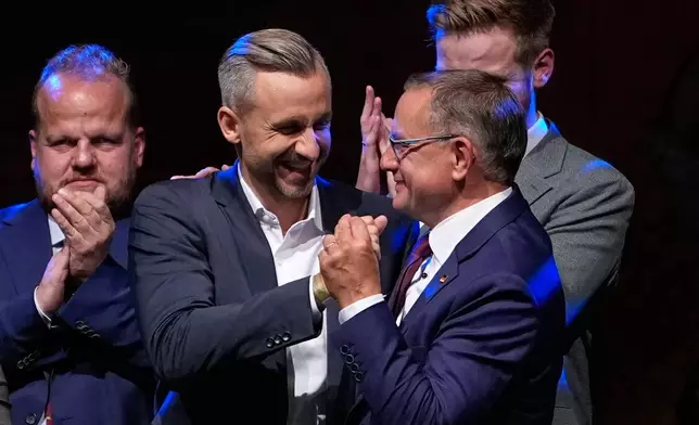 Top candidate Ulrich Siegmund shakes hands with party leader Tino Chrupalla at an election party of the "Alternative for Germany" (AfD) after the Saxony-Anhalt state elections in Magdeburg, eastern Germany, Sunday, Sept. 6, 2026. (AP Photo/Matthias Schrader)