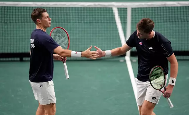 Great Britain's Neal Skupski, left, and Henry Patten celebrate during the Davis Cup qualifier match against Ecuador's Diego Hidalgo and Gonzalo Escobar in London, Sunday Sept. 20, 2026. (John Walton/PA via AP)