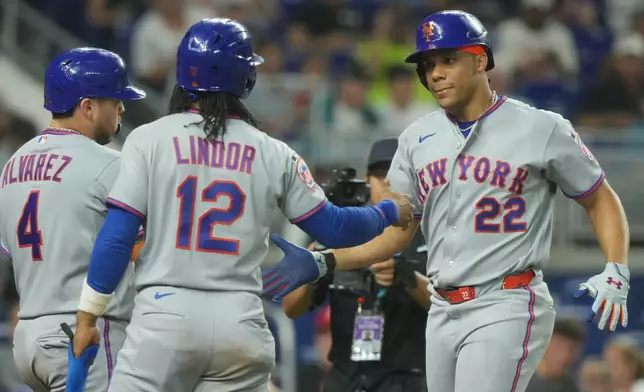 New York Mets' Juan Soto (22) celebrates his three-run home run with Francisco Lindor (12) and Francisco Alvarez (4) during the second inning of a baseball game against the Miami Marlins Tuesday, Sept. 8, 2026, in Miami. (AP Photo/Marta Lavandier)