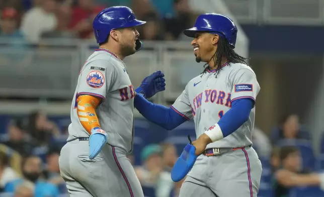 New York Mets' Francisco Alvarez, left, and Francisco Lindor (12) celebrate after scoring on a three-run home run by Juan Soto during the second inning of a baseball game against the Miami Marlins Tuesday, Sept. 8, 2026, in Miami. (AP Photo/Marta Lavandier)
