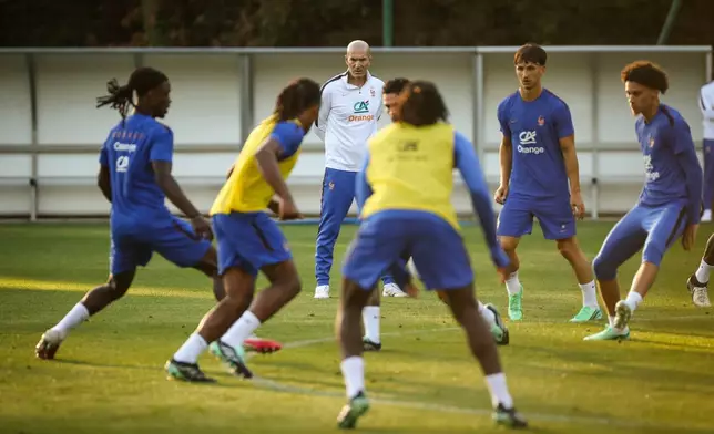 France national soccer team coach Zinedine Zidane, center back, attends a training session with the team at their training center in Clairefontaine, France, west of Paris, Monday, Sept. 21, 2026. (AP Photo/Thomas Padilla)