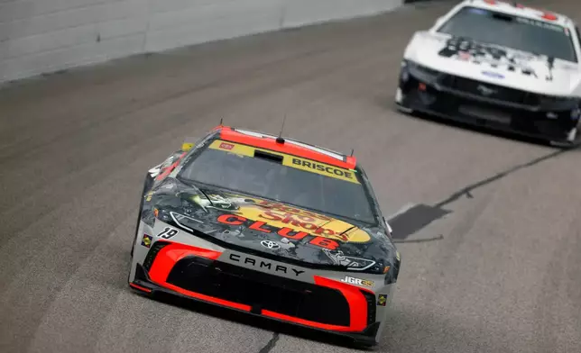 Chase Briscoe (19) heads through Turn 1 during a NASCAR Cup Series auto race in Kansas City, Kan., Sunday, Sept. 27, 2026. (AP Photo/Colin E. Braley)