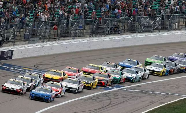 Denny Hamlin, front left, and Kyle Larson, front right, lead other drivers at the start of the second stage during a NASCAR Cup Series auto race at Kansas Speedway in Kansas City, Kan., Sunday, Sept. 27, 2026. (AP Photo/Colin E. Braley)