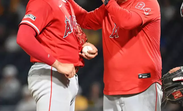Los Angeles Angels rerlief pitcher Samy Natera Jr. gets a mound visit from pitching coach Tim LeLeveque during the eight inning as they take on the Pittsburgh Pirates in a baseball game, Friday, Sept. 4, 2026, in Pittsburgh. (AP Photo/Philip G. Pavely)